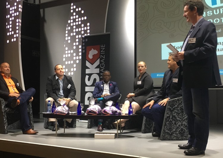 Insurance Bootcamp facilitator Tim Timmerman introducing panelists sitting on stage