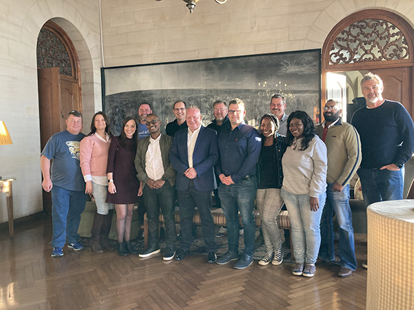 Professional team gathered together in a hall, smiling