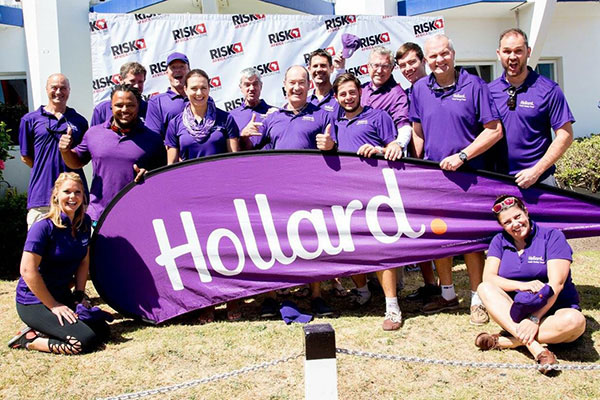 The Hollard RiskAfrica Team standing proudly with a Hollard Banner