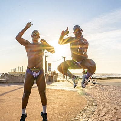 Two participants jumping at sunrise before the Hollard Daredevil Run 2025