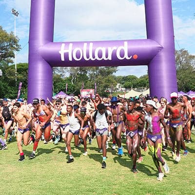 Participants start the Hollard Daredevil Run 2025 beneath the Hollard arch