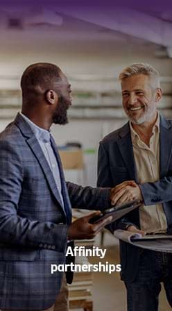Business professionals shaking hands, illustrating an affinity partnership.