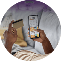 Person making an online purchase using a smartphone and bank card