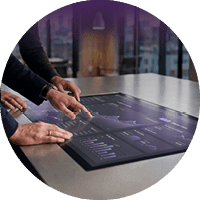 Professionals reviewing financial data on a digital touchscreen