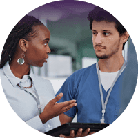 Healthcare professionals discussing information on a tablet