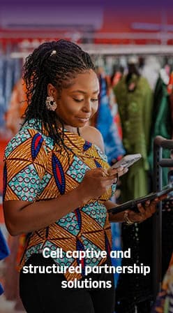 Retail business owner using digital devices, illustrating a cell captive partnership solution.