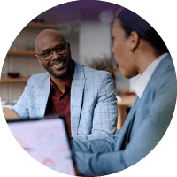 Two banking professionals having a discussion at a desk