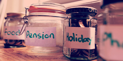 Savings jars representing setting aside money to invest in a Hollard Endowment Plan