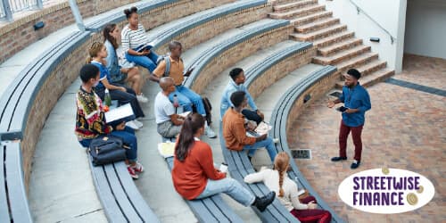 A group of people on steps, listening to a speaker share information about Hollard’s financial education programme, Streetwise Finance.