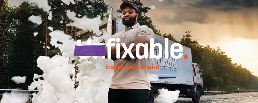 A truck driver standing by his truck insured by Hollard Trucking Insurance #InsureYourUnsure