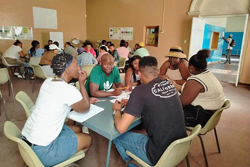 Students talking at the table in the classroom for the Hollard Streetwise Finance Rural SMME project