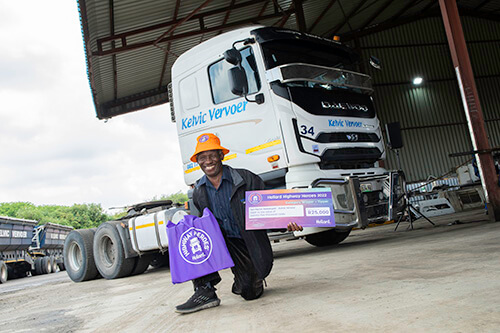 Tori Martin Ramokgadi posing with his award by a truck