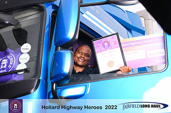 Ronald Ntombela in a truck showing his Highway Heroes award through the window